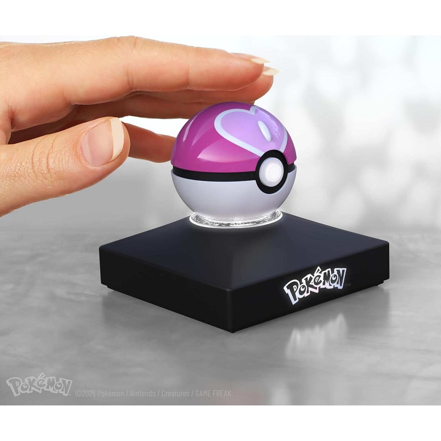 The Wand Company Pokémon Trainer Mini Poké Ball Range of Authentic Replicas - Realistic, Electronic, Die-Cast Poké Ball with Display Stand Light Features (Love Ball)